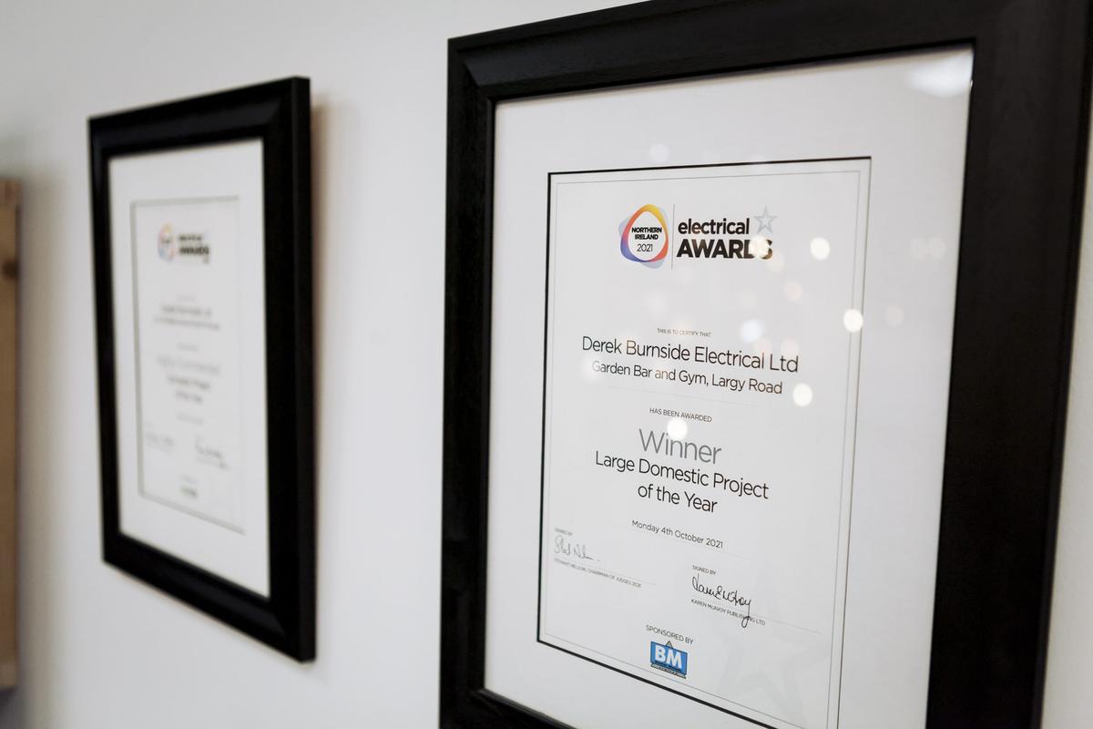 Northern Ireland Electrical Awards 2021 certificate awarded to Derek Burnside Electrical Ltd, framed on the office wall