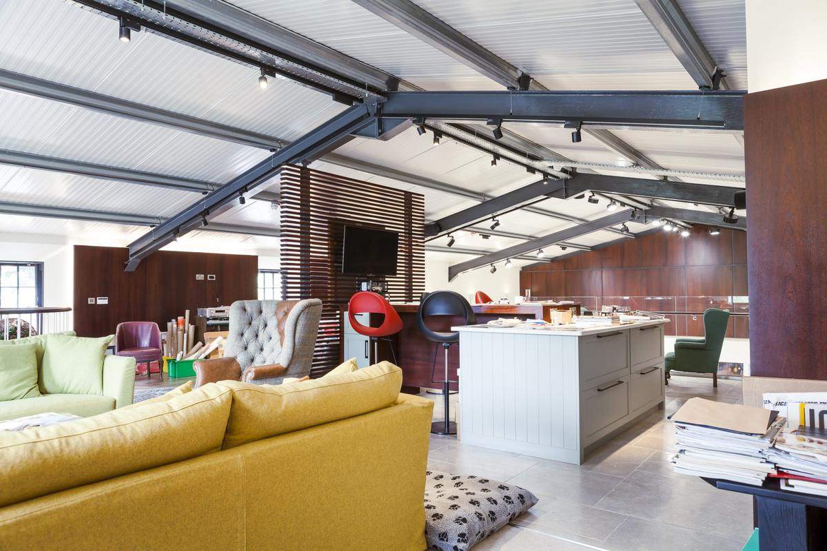 Open plan living and kitchen space with track lighting and integrated AV installed by Derek Burnside Limited